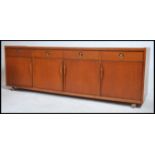 A 1970's retro teak low sideboard dresser unit of Danish inspiration. Raised on castors to the