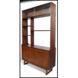 A 1970's Danish teak room divider having turned legs with a series of cupboard and drawers to the