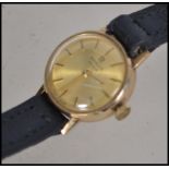 A 9ct gold Marvin Revue Swiss movement ladies cocktail watch having leather strap. Marked to