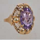 A believed Victorian 585 / 14ct gold and amethyst dress ring. The large oval amethyst being claw