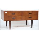 A 1970's retro Danish inspired teak wood low sideboard cabinet raised on tapered legs with a