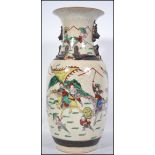 A large late 19th / early 20th century Chinese crackle glaze vase depicting warrior scenes in the