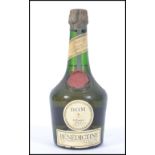 An unopened original old bottle of famed herbal liqueur Benedictine dating to the circa 1950's.
