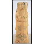 A 19th century Chinese / Japanese carved okimono bone figurine of an elder having a character seal