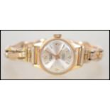 An 18ct gold ladies Cauny Prima Swiss made 17 ruby movement dress / cocktail watch having a silvered