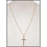 A 9ct gold rolo link necklace chain with spring hoop clasp having a 9ct gold crucifix pendant. Total