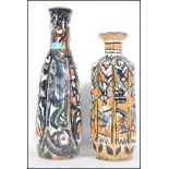Two vintage 20th century studio pottery clay vases both having a striking hand painted finish, no