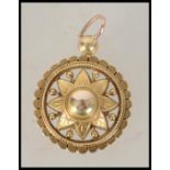 An 18ct gold necklace pendant having a central star flower with roundel to centre, a bevelled rope