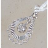 A white gold pendant with central floating stone (diamond?) stamped 750 to link for 18 ct gold.