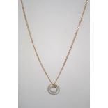 A ladies 9ct gold necklace pendant and chain. The pendant of roundel form on a 52cms length chain