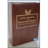 An album of seventy - four Golden Replicas of United States Stamps / First Day Of Issue proof