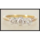 A vintage ladies 18ct gold, platinum and diamond 3 stone ring. The 3 diamonds being round cut approx