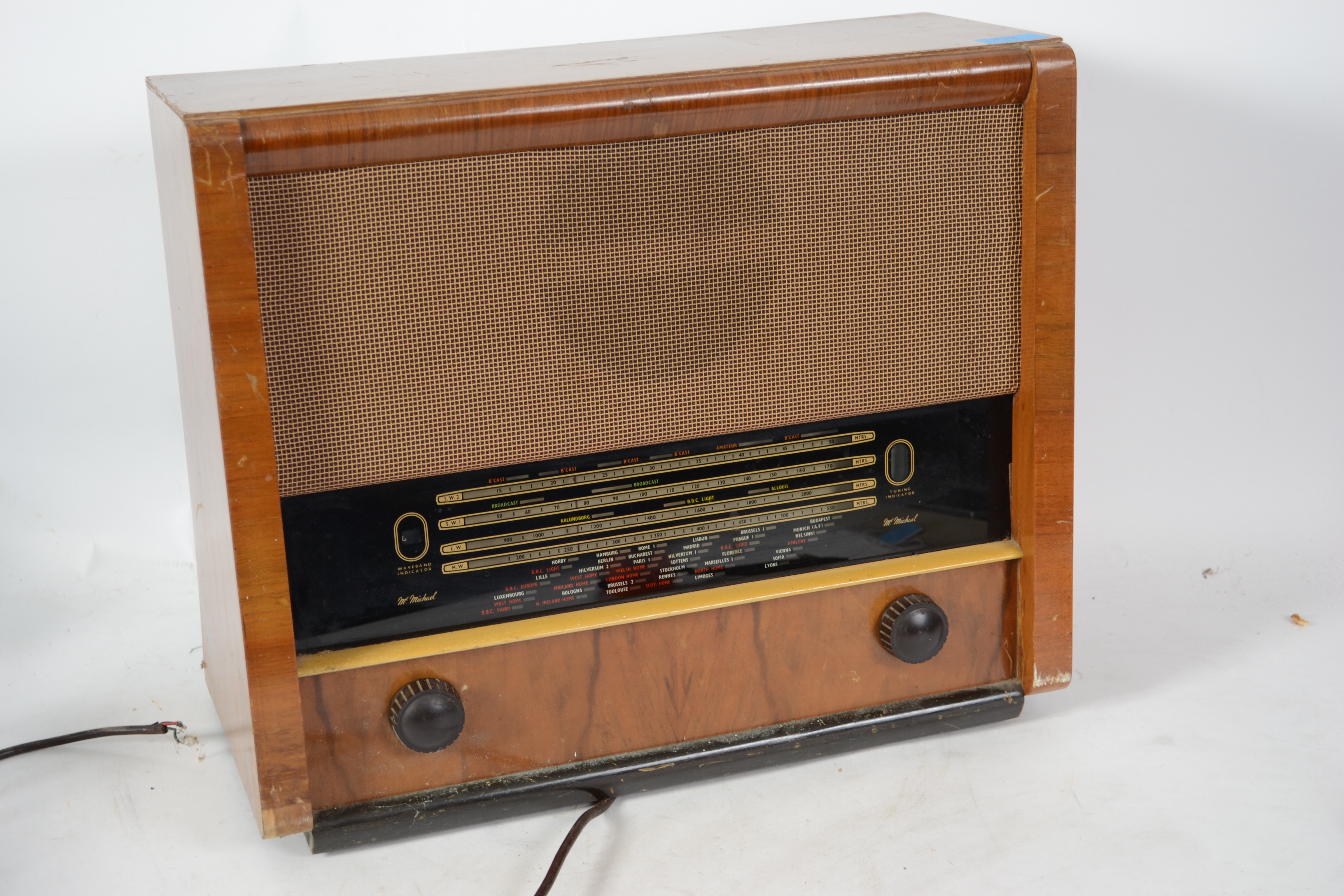 A vintage 20th century Art Deco walnut cased radio by McMichael having a decorative face within