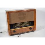 A vintage 20th century Art Deco walnut cased radio by McMichael having a decorative face within