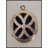 A 9ct gold locket pendant having pierced butterfly design to front and floral design to verso with