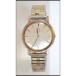 A vintage mid century 9ct gold Omega gentlemen's wristwatch having a silver dial with baton