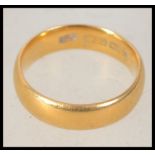 A hallmarked Victorian 22ct gold band ring bearing Birmingham assay marks. Rubbed makers marks