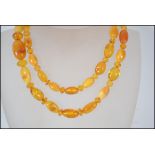 A vintage 20th century butterscotch amber ladies bead necklace having shaped amber beads complete