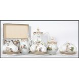 A 20th century tea service by Limoges consisting of teapot, trios, lidded sugar bowl and creamer.