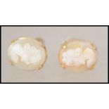 A pair of 9ct gold mounted screw back cameo earrings having rope twist borders