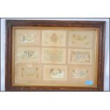 A framed and glazed collection of World War One silk postcards, each of decorative form being