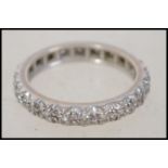 An 18ct white gold and diamond ladies eternity ring, each diamond being illusion set. Total weight