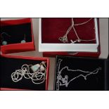 A small collection of three boxed silver jewellery necklaces each with pendants together with a pair