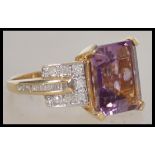 A 14ct yellow gold amethyst and diamond ladies rin