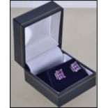 A pair of ladies silver and amethyst stud earrings