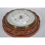 A  1920's oak cased wall barometer having ceramic