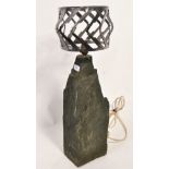 A large heavy stone and cut polished steel table lamp. Heavy stone fragment base with applied bulb