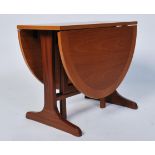 A retro 1970's Parker Knoll small drop leaf teak wood occasional table being raised on splayed
