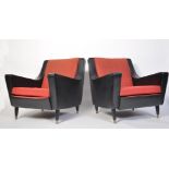 A pair of mid century retro two tone armchairs having black vinyl and red moquette fabrics to an