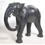 A large floorstanding leather elephant originally retailed by Maples & Co of London. Glass eyes with