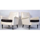 A  retro 1960's pair of Greaves & Thomas ' Longline ' vinyl armchairs. Raised on tapering ebonised