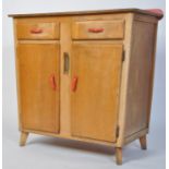 A vintage mid 20th century kitchen sideboard in beech wood with oak veneers having a red formica top
