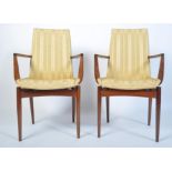 A stunning pair of 1960's rosewood carver armchairs. Raised on tapered legs with angular upholstered