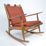 A mid century oak rocking chair by Scandart Furniture. Sleigh runners with shaped elbow supports