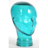 An unusual 20th century teal coloured glass head - bust used for shop display Haberdashery stand.
