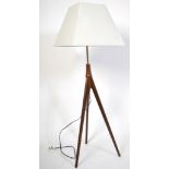 A retro 20th century teak wood Danish inspired standard floor lamp of tripod atomic form with