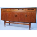 A 1970's retro G-Plan ' Fresco ' pattern teak wood sideboard being raised on tapered supports having