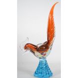 A mid century glass studio art sculpture of a cockerel having a tapered blue glass base, the bird