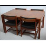 A 1960's teak wood Danish influence dining table and 4 chairs - suite. The table of chunk teak