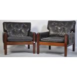 A stunning pair of 1960's teak and leather Danish armchairs. The black leather cushions being button