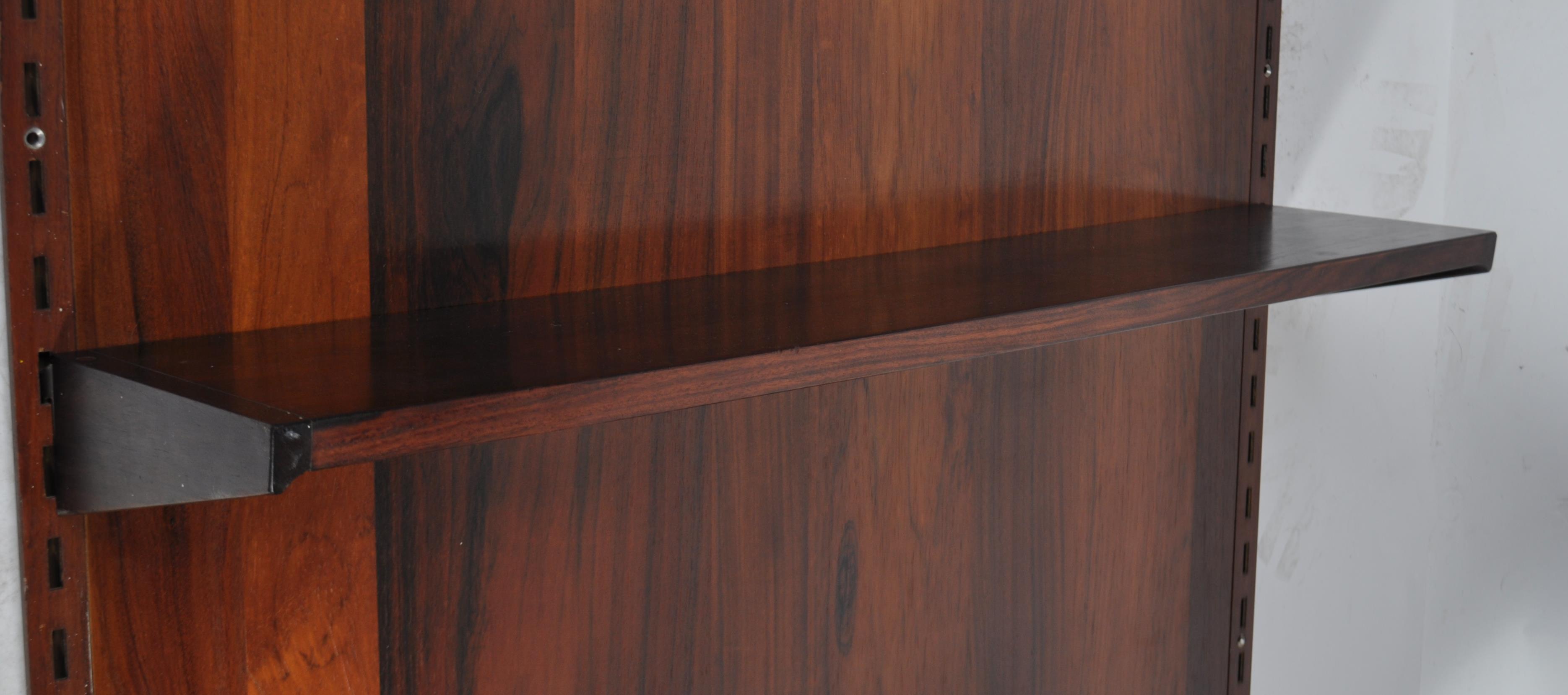 A rare mid century Danish rosewood modular wall system having a large rosewood panel back with - Image 8 of 10