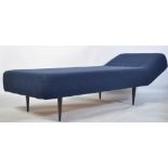 A retro 20th century sofa day bed of large form being raised on angular tapering legs and