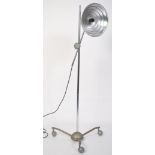 A vintage mid century floor standing adjustable converted heat lamp, having a metal tubular
