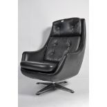 A vintage retro 20th century Danish vinyl upholstered recliner swivel easy chair raised on chromed