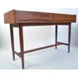 A 1960's teak writing table desk in the manner of Archie Shine for Robert Heritage. The table on