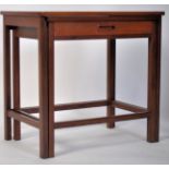 A 1960's unusual G-Plan teak wood nest of tables raised on squared legs with the twin small nests